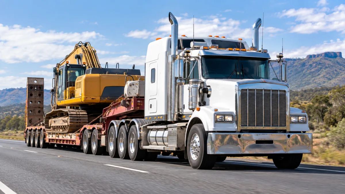 Heavy haulage truck with tag trailer on a highway, representing updated mass and dimension limits