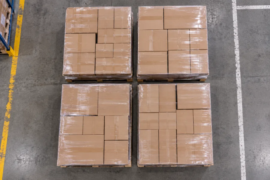 Four wrapped pallets seen from directly overhead on a warehouse floor