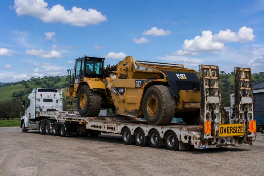 Oversize machine on a low-loader in the green south-east