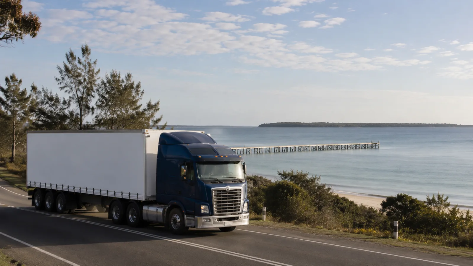 Semi-trailer on the coastal road at Hervey Bay with the bay and island beyond