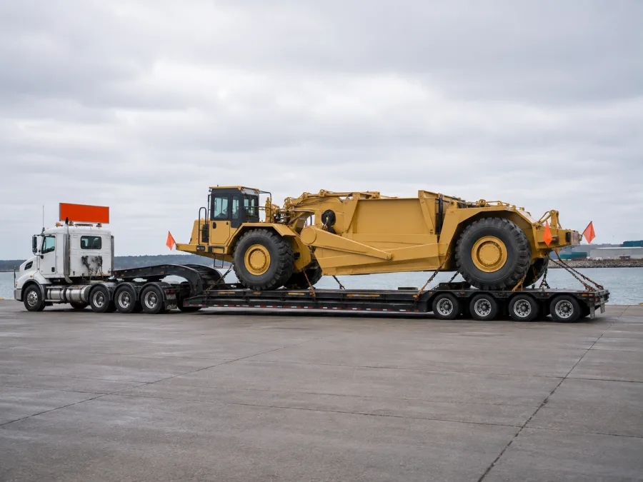 Oversize machine on a low-loader at a ferry terminal hardstand