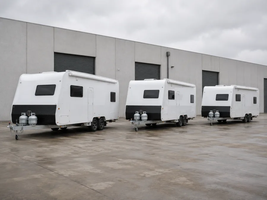 New caravans lined up outside a Victorian manufacturing plant for delivery north