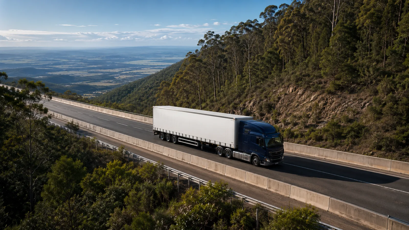 Semi-trailer climbing the forested Toowoomba Range escarpment