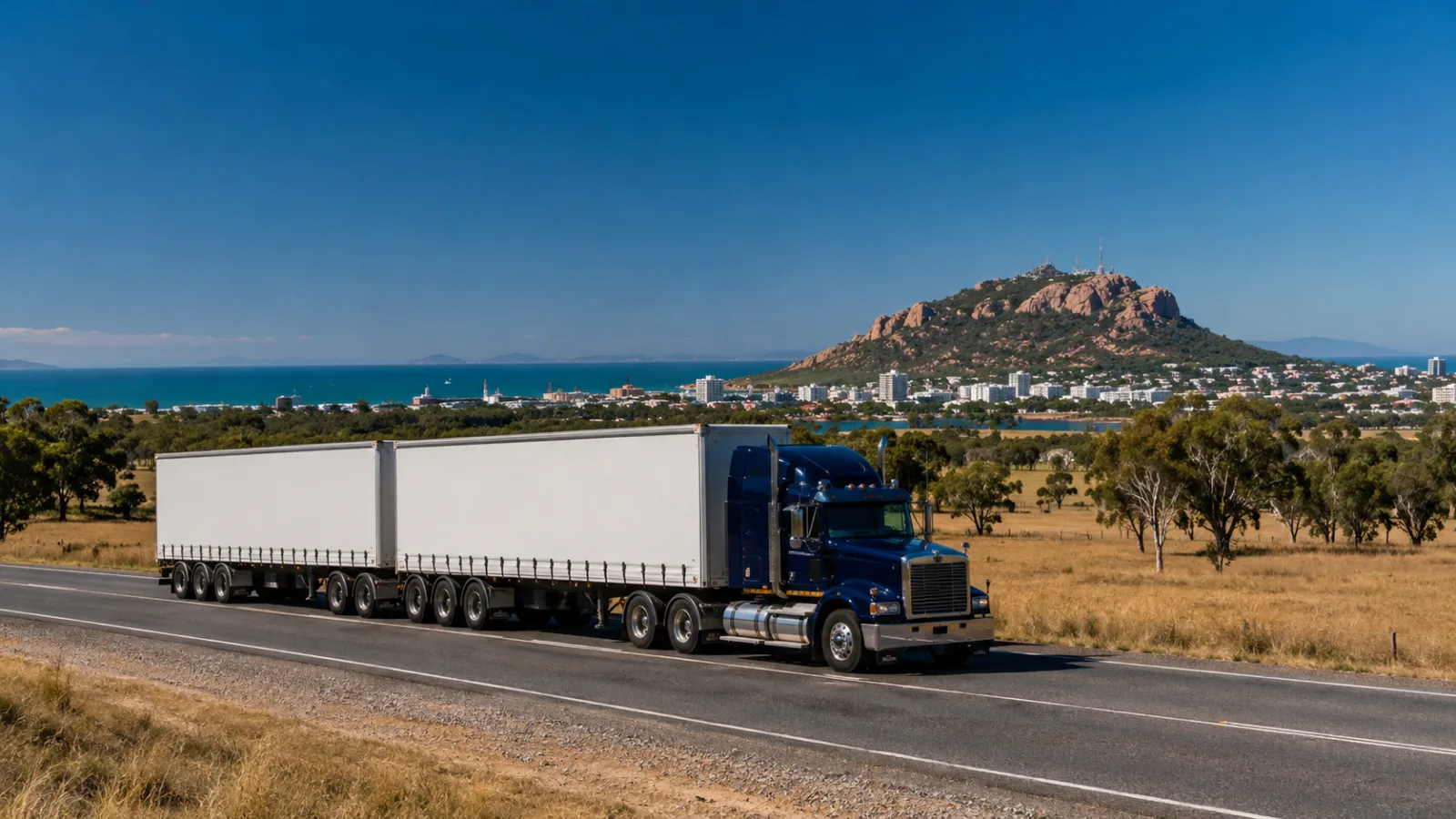 B-double approaching Townsville with the rocky hill and dry grazing country