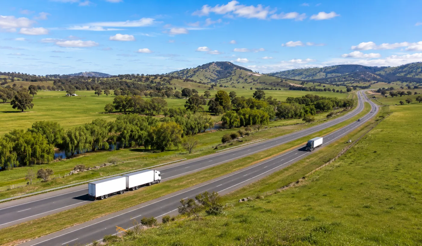 Dual carriageway Hume Highway sweeping through green Riverina farmland
