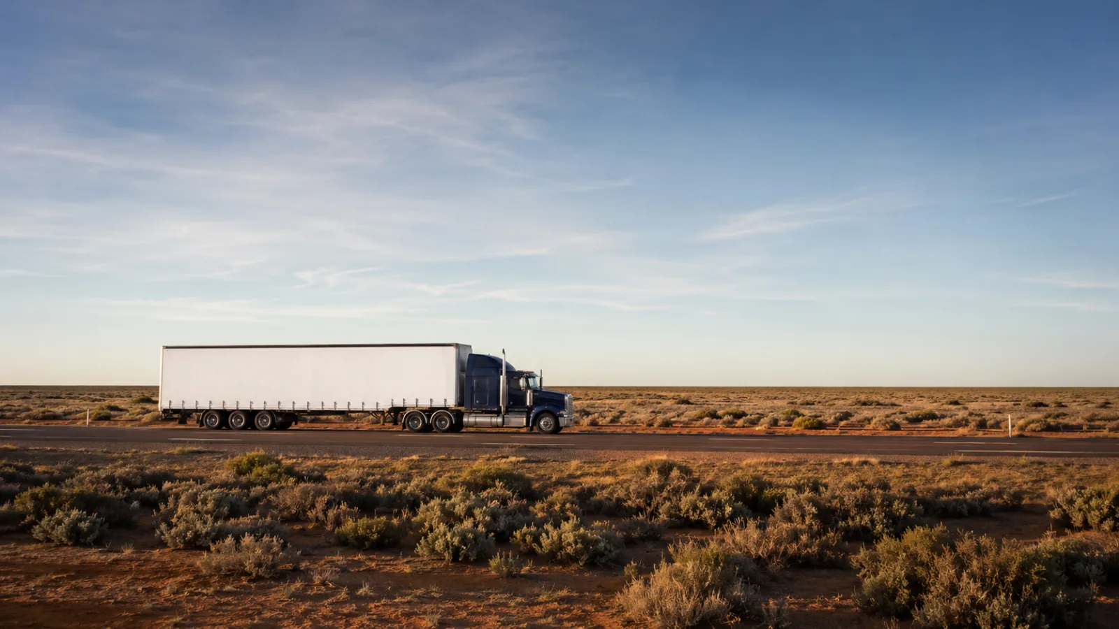 Semi-trailer crossing the treeless Hay Plain on the Sturt Highway heading west