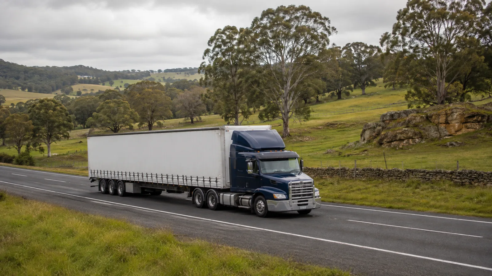 Semi-trailer on the Hume through southern highlands pastoral country