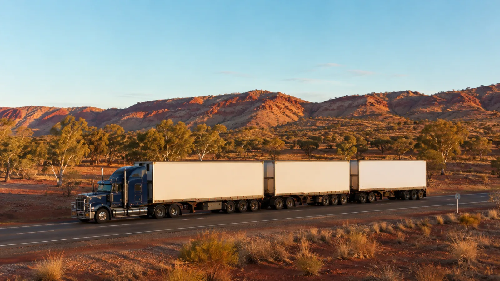 Road train on the Stuart Highway with the ranges behind approaching Alice Springs