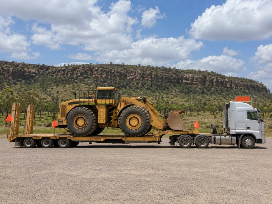 Oversize machine on a low-loader in Top End savannah country